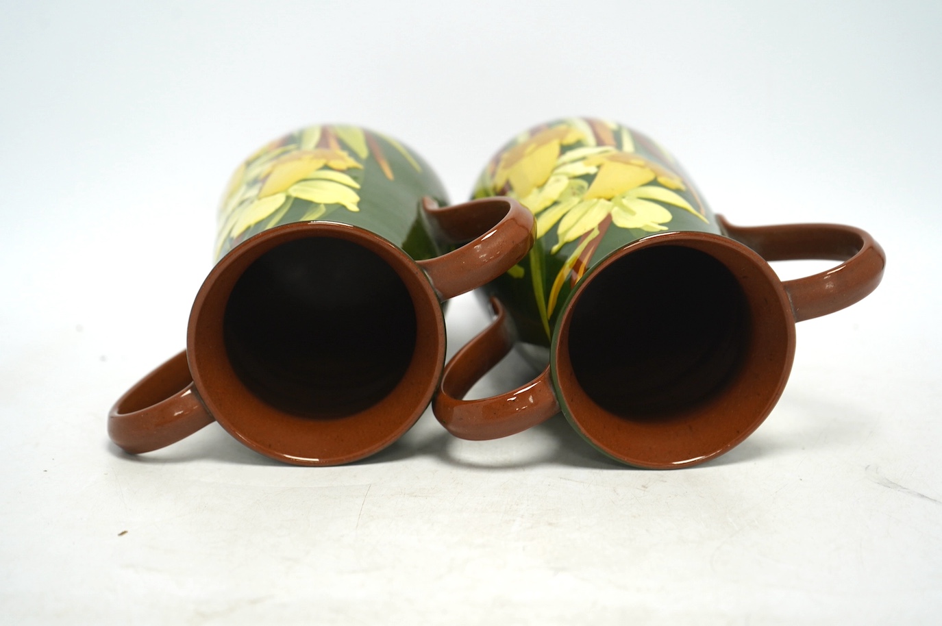 A pair of Watcombe Torquay vases decorated with daffodils, 20cm high. Condition - good